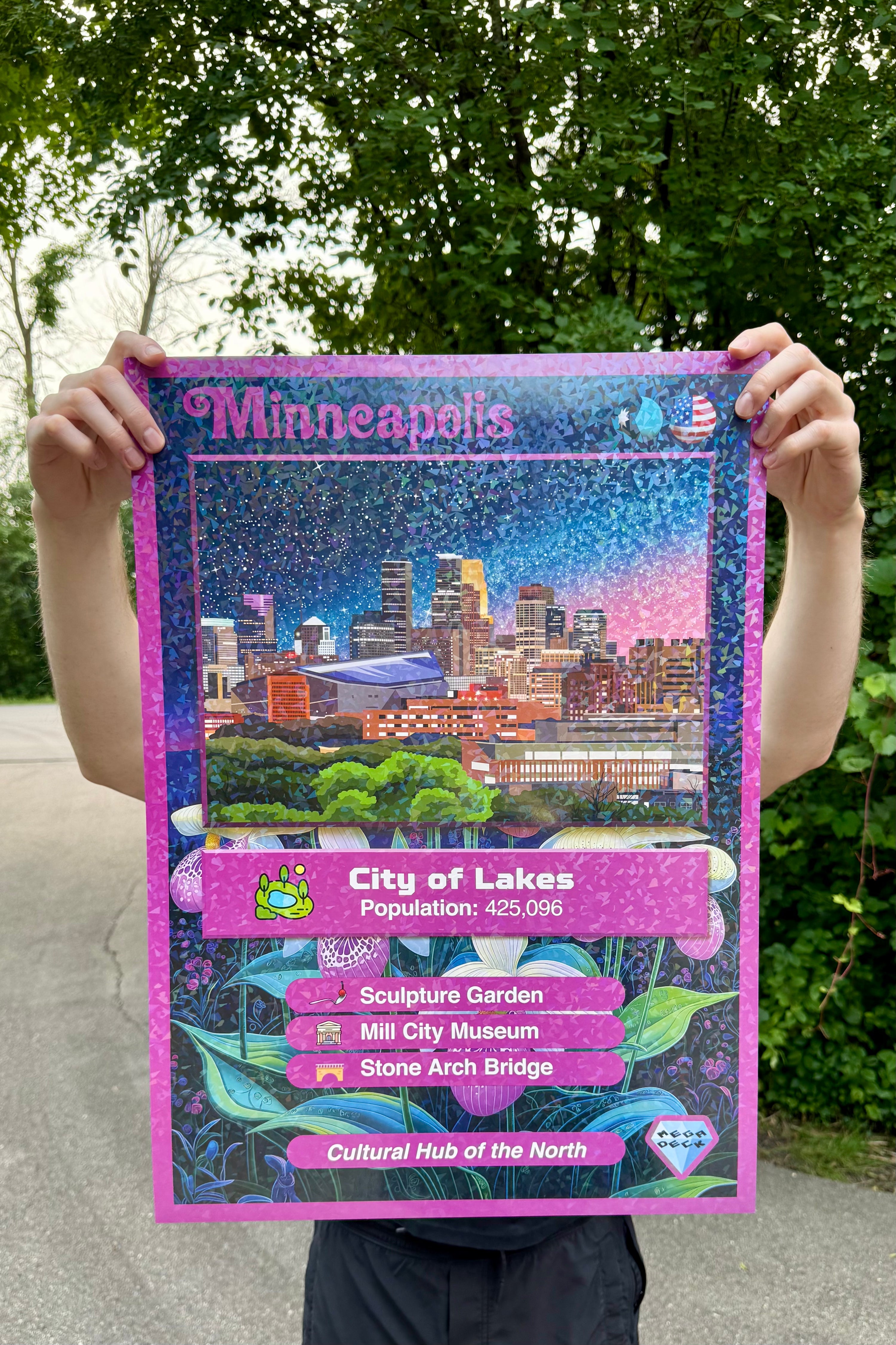 Person holding a Minneapolis-themed trading-card style art print with city skyline and attractions.